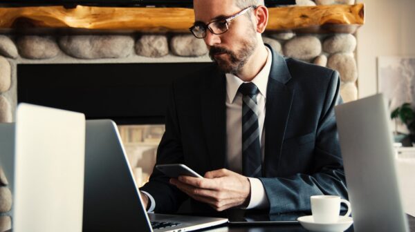 man in black holding phone